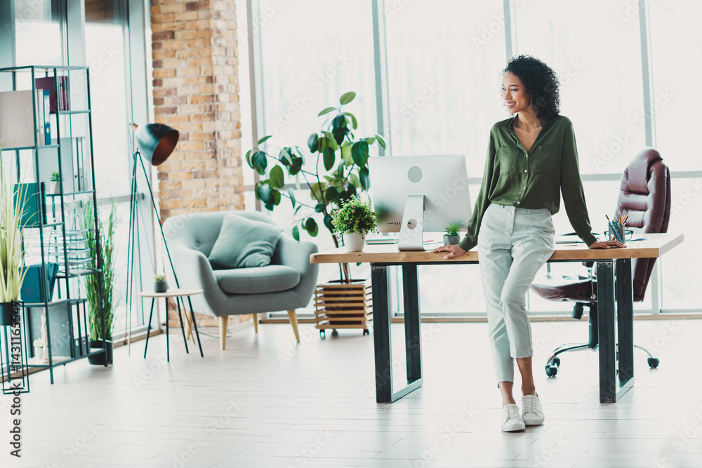 Young businesswoman at a bright modern office, showcasing casual style and professional confidence in a natural and inspiring workspace Young businesswoman at a bright modern office, showcasing casual style and professional confidence in a natural and inspiring workspace