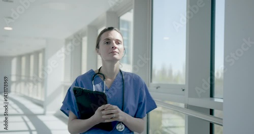 Wallpaper Mural Female Nurse with Medical Tablet Walking in Hospital Torontodigital.ca