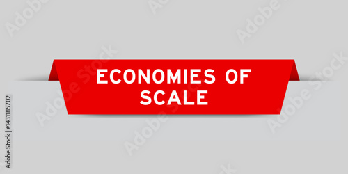 Red color inserted label with word economies of scale on gray background