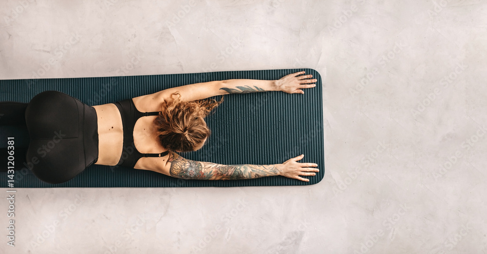 Woman Practicing Yoga and Stretching in Puppy Pose