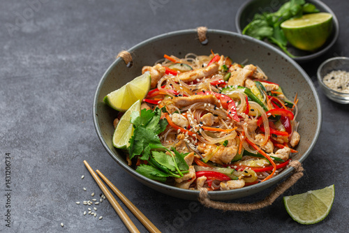 hot and spicy rice noodles with chicken and  vegetables photo
