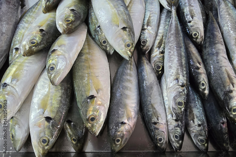 Close-up view of freshly caught fish arranged on ice at a wet market seafood counter. Close-up view of freshly caught fish arranged on ice at a wet market seafood counter.