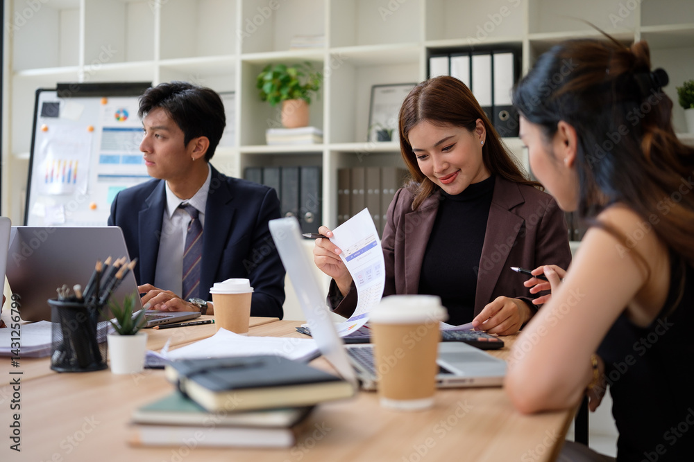 Diverse group of coworkers analyzing data and discussing strategy in modern office. Diverse group of coworkers analyzing data and discussing strategy in modern office.