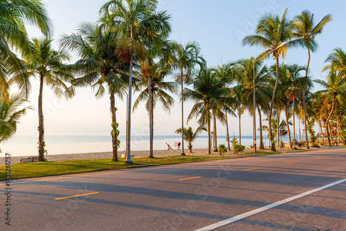 Fototapeta Naklejka Na Ścianę i Meble -  Beach road and coconut trees along the tropical seaside,Beautiful beach road in Thailand