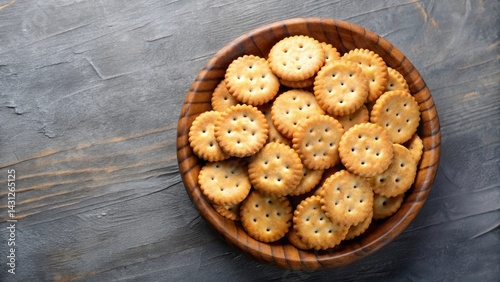 Round salted crackers in a wooden bowl, top view isolated on background , snack time, kitchen,  snack time, kitchen, food
