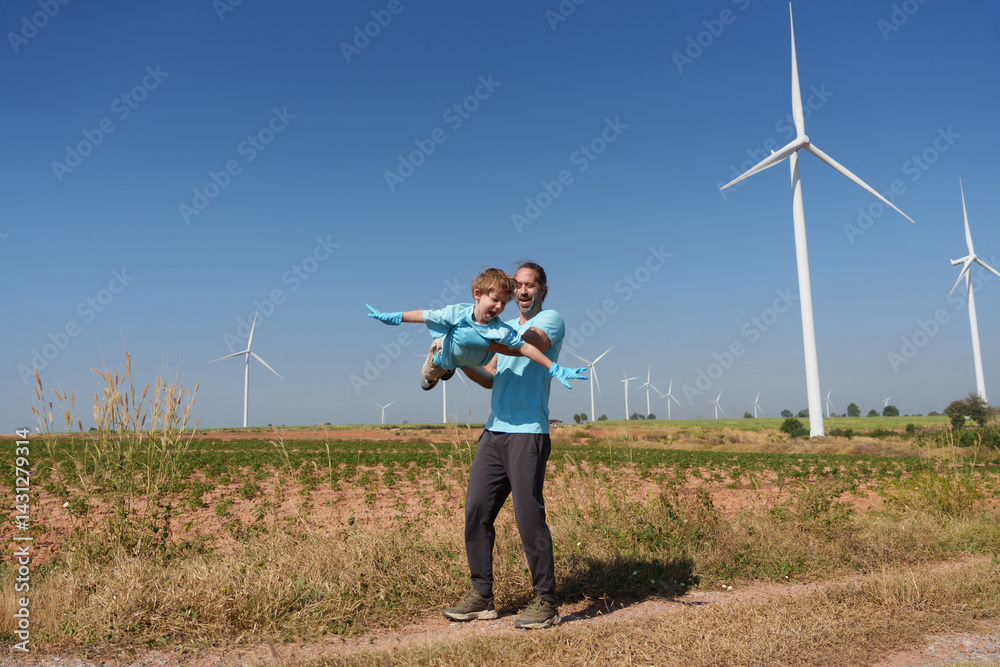 custom made wallpaper toronto digitalA happy father carries his smiling son in the air with a windmill and a sky with clouds in the background.
