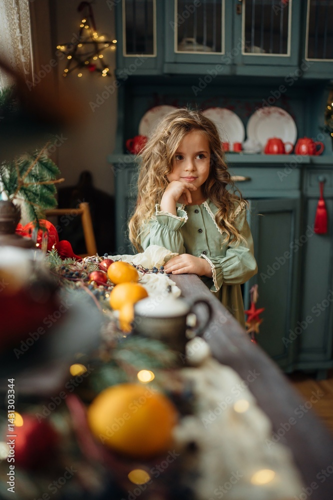 little beautiful girl at the festive New Year's table. family traditions.