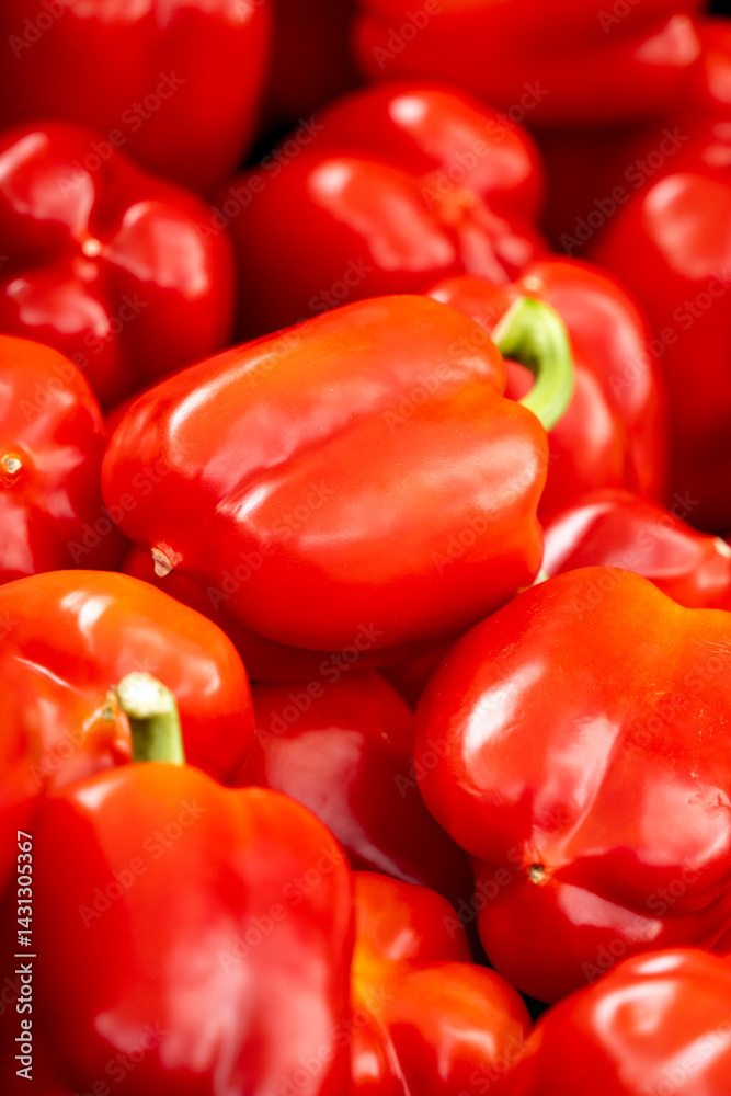 A bunch of red peppers are piled on top of each other A bunch of red peppers are piled on top of each other