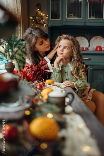 Obraz na płótnie Mother and daughter at the festive New Year's table. family traditions. w salonie