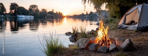 Obraz na płótnie Enjoy a tranquil evening by the lake with a camping tent and a warm bonfire as the sun sets over the horizon w salonie