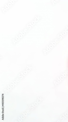 Pink ink flowing and spreading in water creating elegant swirling patterns. The vibrant magenta liquid disperses gradually, forming mesmerizing abstract shapes against white background with copy space