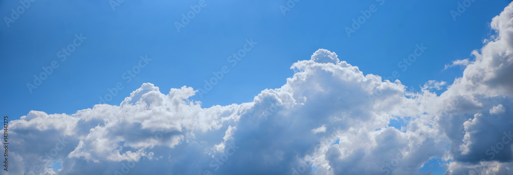 wide sky background with heaps of cumulus clouds in the lower half, blue space above