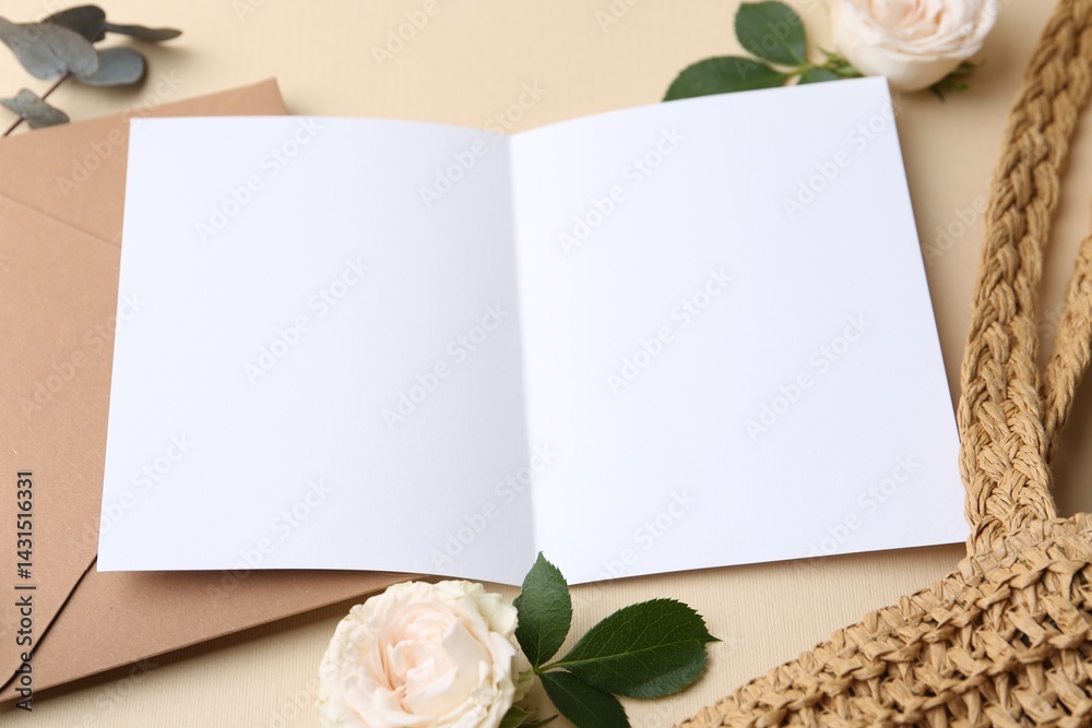 Blank greeting card, envelope, roses, bag and eucalyptus leaves on beige background, closeup Blank greeting card, envelope, roses, bag and eucalyptus leaves on beige background, closeup