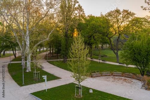 Obraz na płótnie Spring moments in City park of Budapest. Hungarian name is Varosliget. Amazing sunny day with bright lights. The branches of trees are green because many leaves are growing on it. w salonie