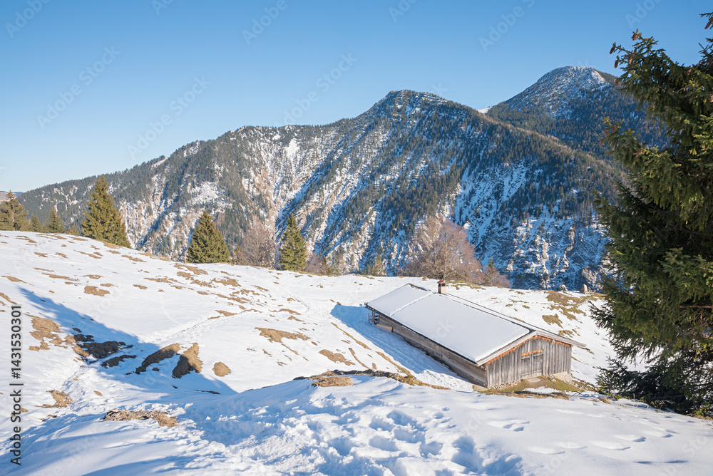 snowy footpath at Seeberg mountain, wooden hut, hiking in the bavarian alps in winter