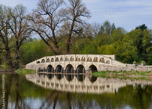 An old stone bridge on the shore of the lake.
