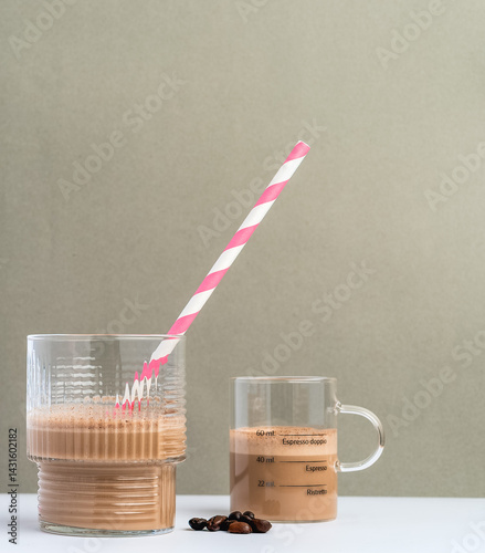 Close-Up of Two Coffee Glasses with Foam and Pink Straw
