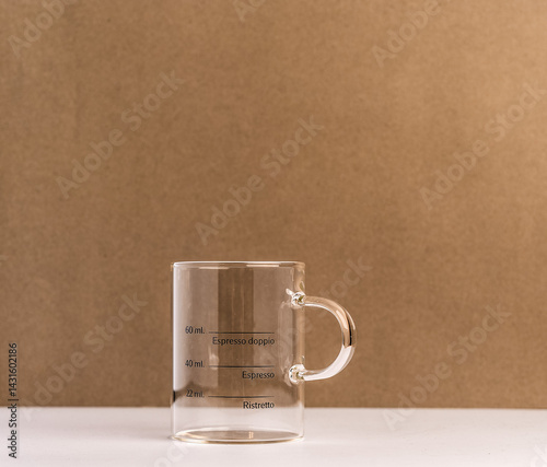 Clear Coffee Mug with Measurement Indicators on Neutral Background
