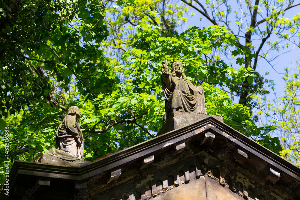 Historic Statue on the spring mystery old Prague Cemetery, Czech Republic