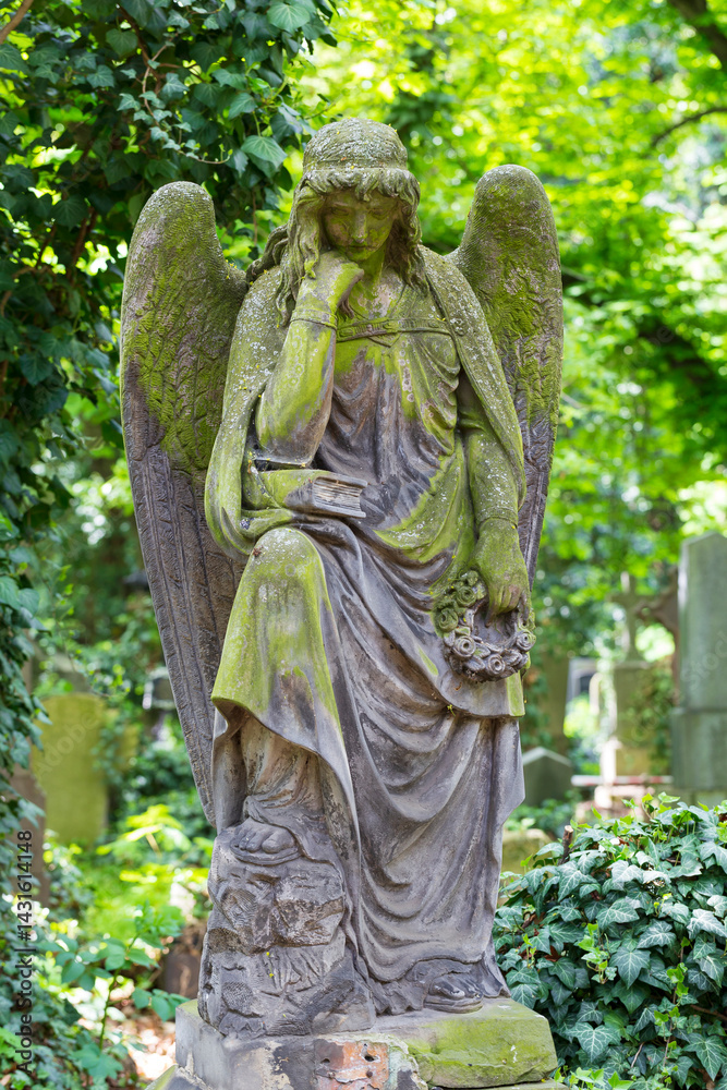 Historic Statue on the spring mystery old Prague Cemetery, Czech Republic