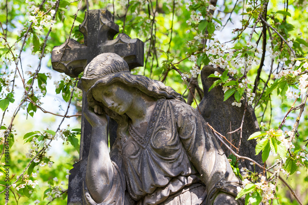 Historic Statue on the spring mystery old Prague Cemetery, Czech Republic