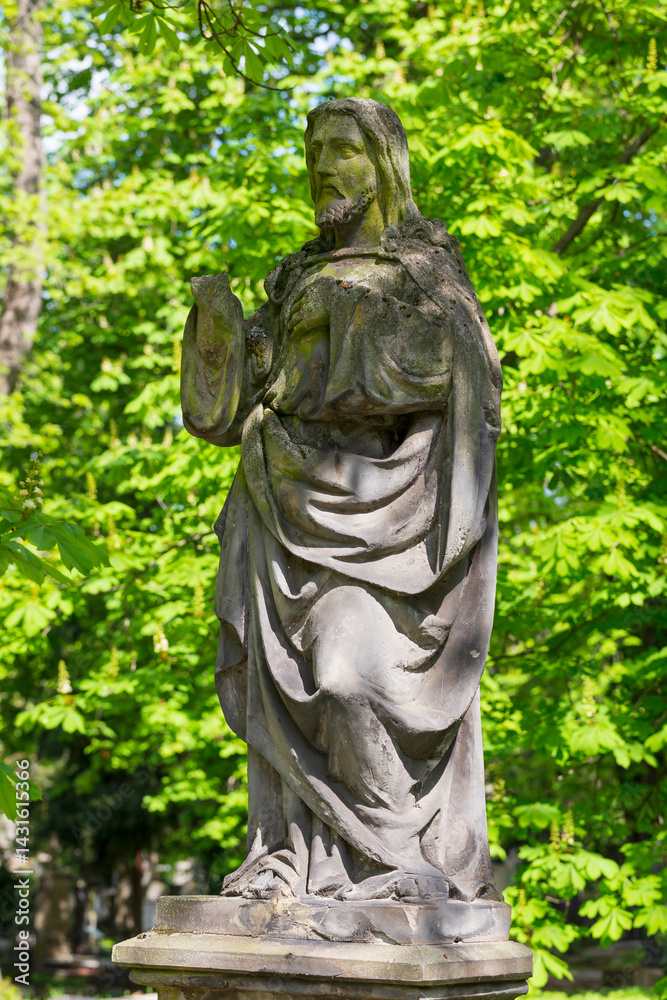 Historic Statue on the spring mystery old Prague Cemetery, Czech Republic