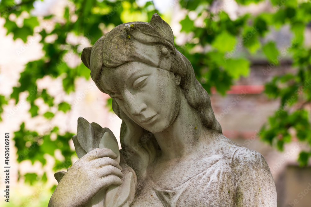 Historic Statue on the spring mystery old Prague Cemetery, Czech Republic