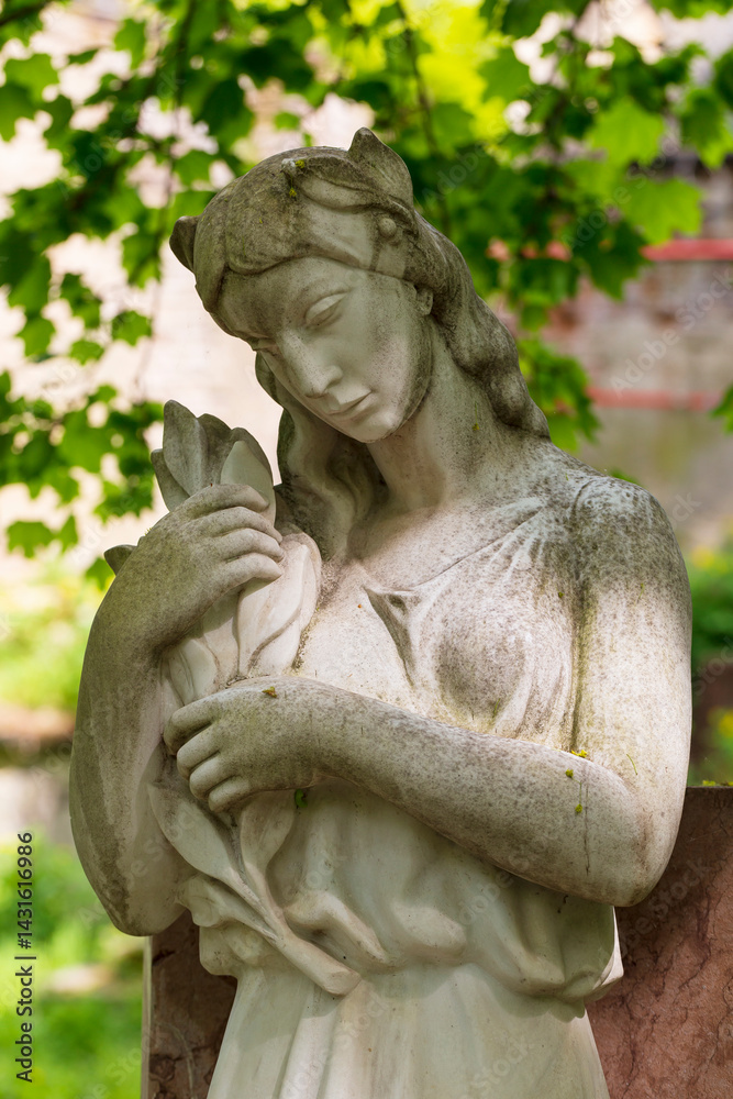 Historic Statue on the spring mystery old Prague Cemetery, Czech Republic