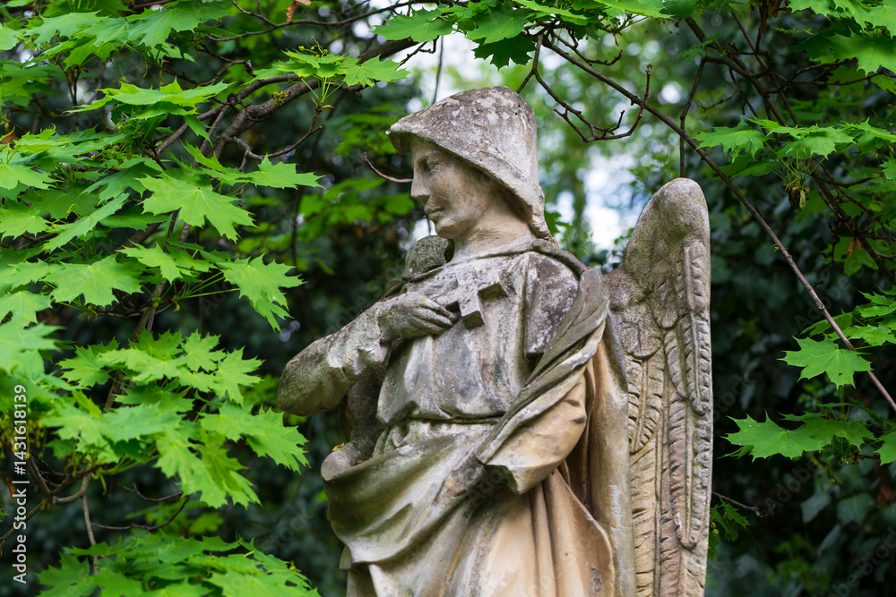 Historic Statue on the spring mystery old Prague Cemetery, Czech Republic