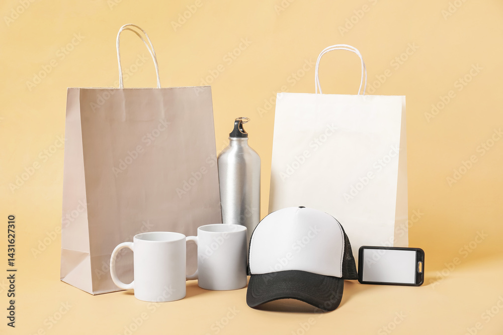 Different blank items for branding on beige background. Mockup for design
