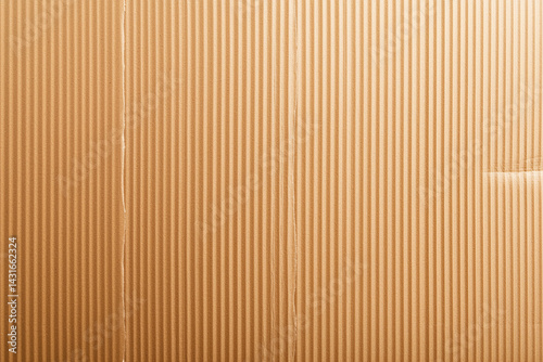 close up view of beige cardboard texture, showcasing its ribbed surface and subtle imperfections. This captures simplicity and versatility of cardboard material, often used packaging and crafts