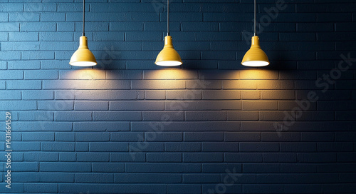 Three yellow pendant lights illuminate textured blue brick wall, creating warm and inviting atmosphere. contrast between colors enhances visual appeal
