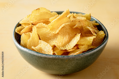 Bowl that holds golden and crispy chips fries.