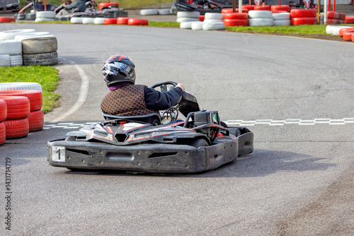 Obraz na płótnie Exciting go-karting adventure on a thrilling racing track during bright afternoon w salonie
