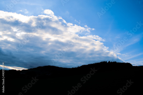 Obraz na płótnie Dramatic Clouds Over Dark Hilly Silhouette Landscape w salonie