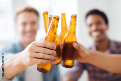 close-up of group of friends toasting with beer bottles at bachelor party