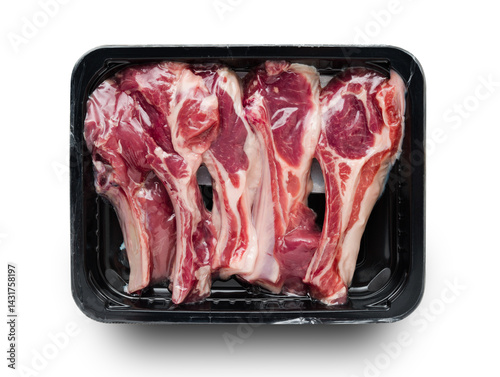 Racks of lamb in vacuum black package, top view on white background