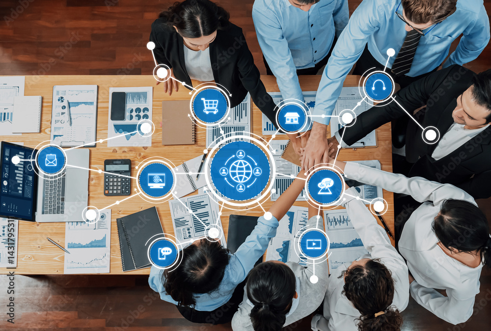 A top-down view of a business meeting showcasing teamwork and strategy with modern technology, data analysis tools, and collaborative interaction in a dynamic office setting. Amity