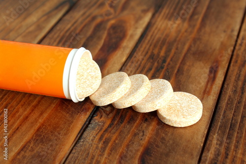 There are effervescent tablets on the wooden table.