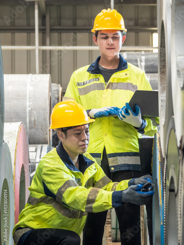 Leader manager talk work order staff male engineer technician team in hard hat hand holding laptop discuss working heavy machine new project business technology produc in industry factory warehouse