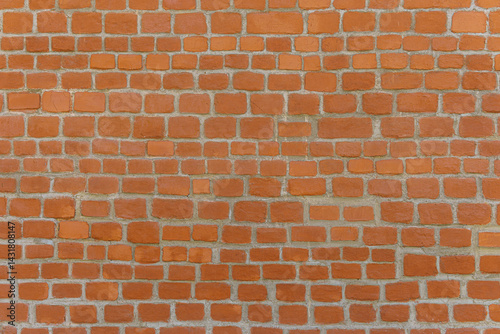 Red brick colored brick wall. The bricks form a pattern.