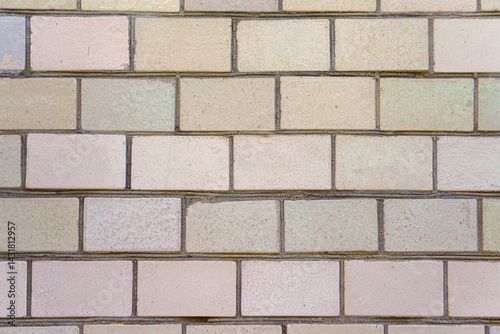A brick wall with a white brick. The bricks are stacked on top of each other.