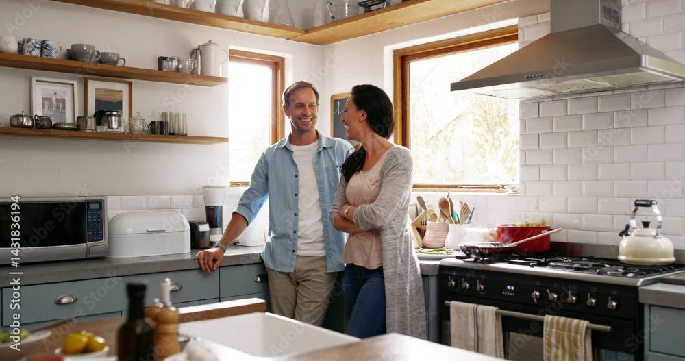 Happy, couple and relax by talking in kitchen for communication, morning chat and bonding together. Smile, people and laughing for funny joke with support, discussion and marriage commitment at house Happy, couple and relax by talking in kitchen for communication, morning chat and bonding together. Smile, people and laughing for funny joke with support, discussion and marriage commitment at house