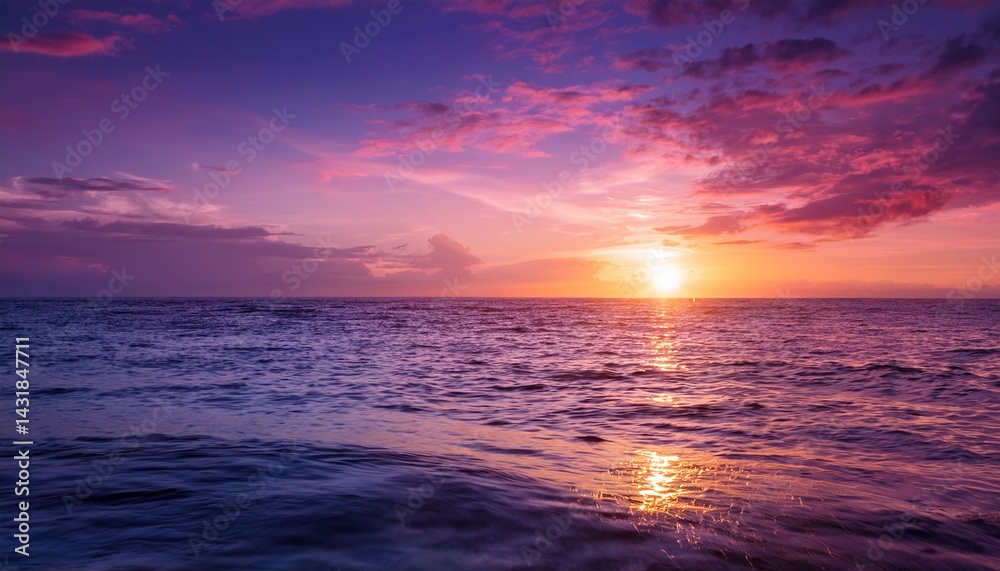 Obraz premium serene sunset over calm ocean awash in vibrant purple and pink hues reflecting light on water surface ideal for tranquil nature imagery or backgrounds