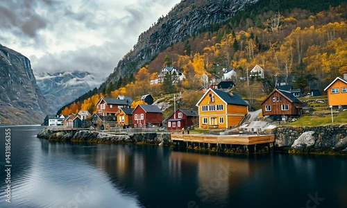 Scenic view of colorful houses along a tranquil fjord with autumn foliage in the background