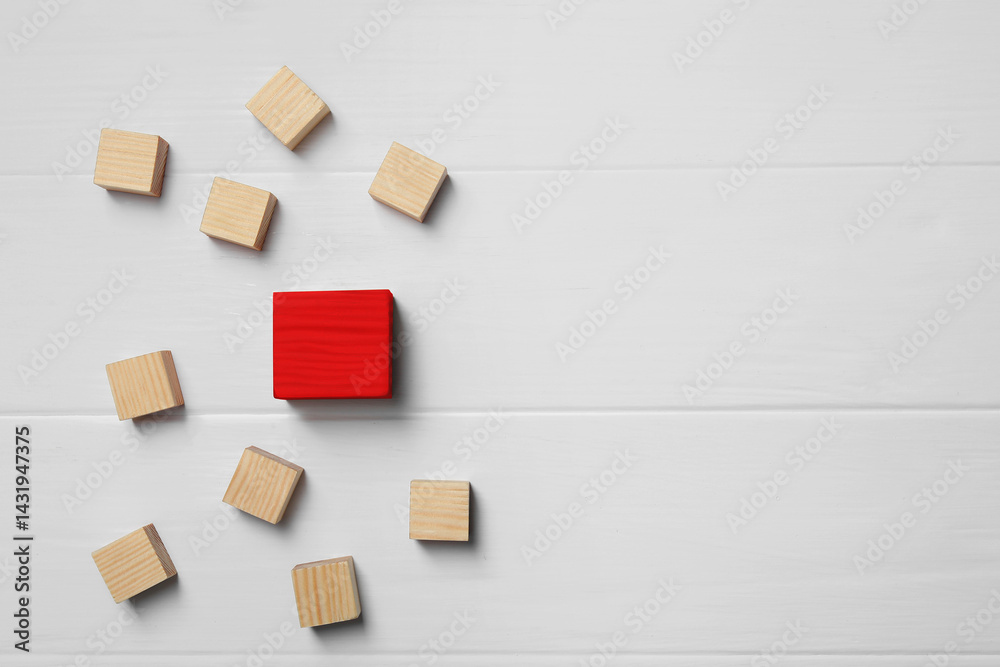 Different, unique, special. Red cube among wooden ones on white table, flat lay. Space for text Different, unique, special. Red cube among wooden ones on white table, flat lay. Space for text