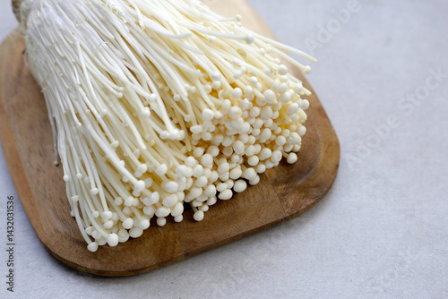 Fresh Enoki mushrooms on white background photo