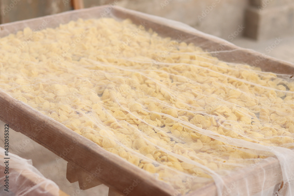 Orecchiette, a type of Italian pasta. Demonstration of the famous Apulian orecchiette common in Italy. Varieties of fresh pasta. Italian pasta in the shape of small ears. Handmade orecchiette pasta