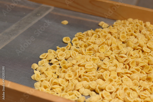 Obraz na płótnie Orecchiette, a type of Italian pasta. Demonstration of the famous Apulian orecchiette common in Italy. Varieties of fresh pasta. Italian pasta in the shape of small ears. Handmade orecchiette pasta w salonie