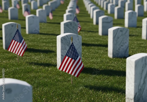 American flags mark the graves of soldiers in a national cemetery on a sunny day.